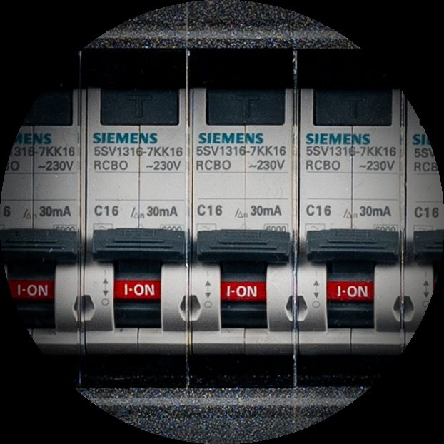 Row of Siemens RCBO breakers switched on inside a Tesla Tech distribution unit