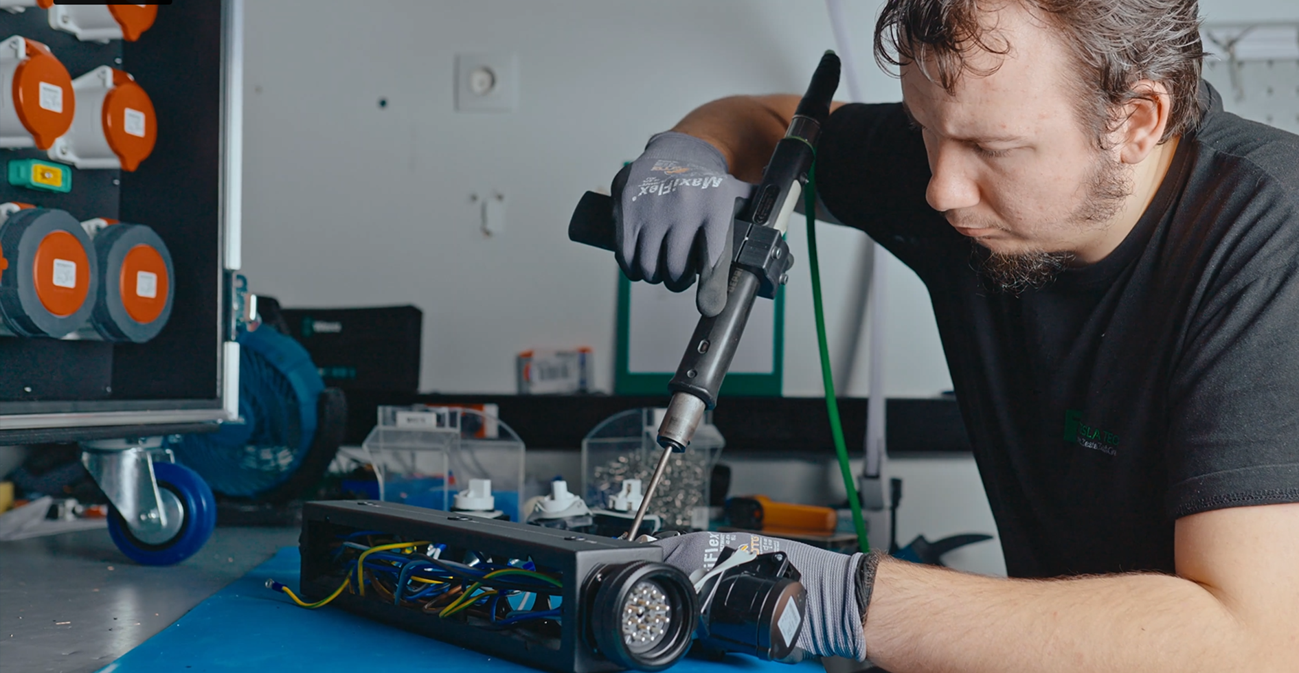 Technician tightening connections with an electric screwdriver