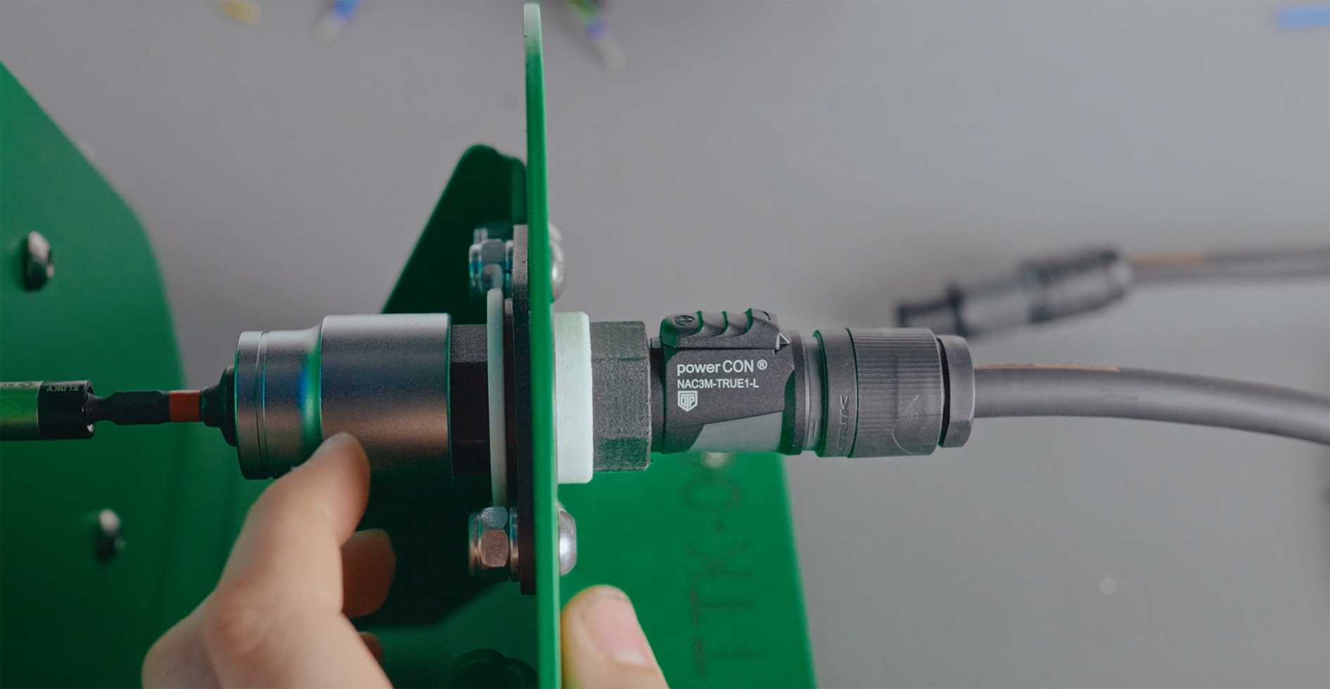 powerCON connector held in a dedicated assembly fixture