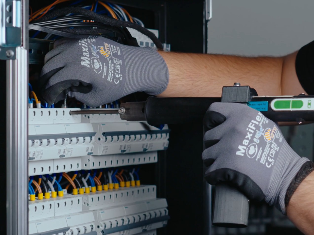 Tesla Tech technician installing circuit breakers inside a flightcase PDU
