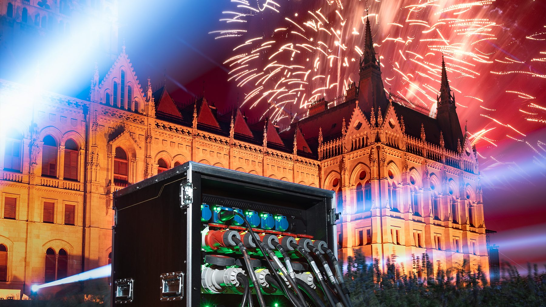 Flightcase PDU and connected cables in a night scene with fireworks and the Hungarian Parliament.